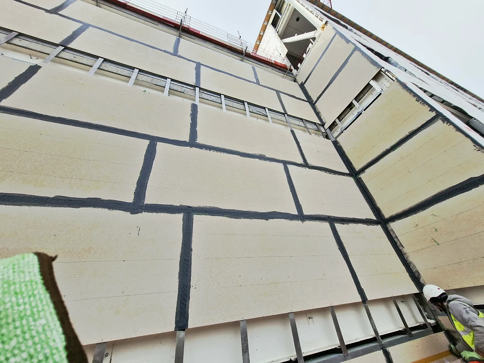 Facade wall boards with taped joints seen from below