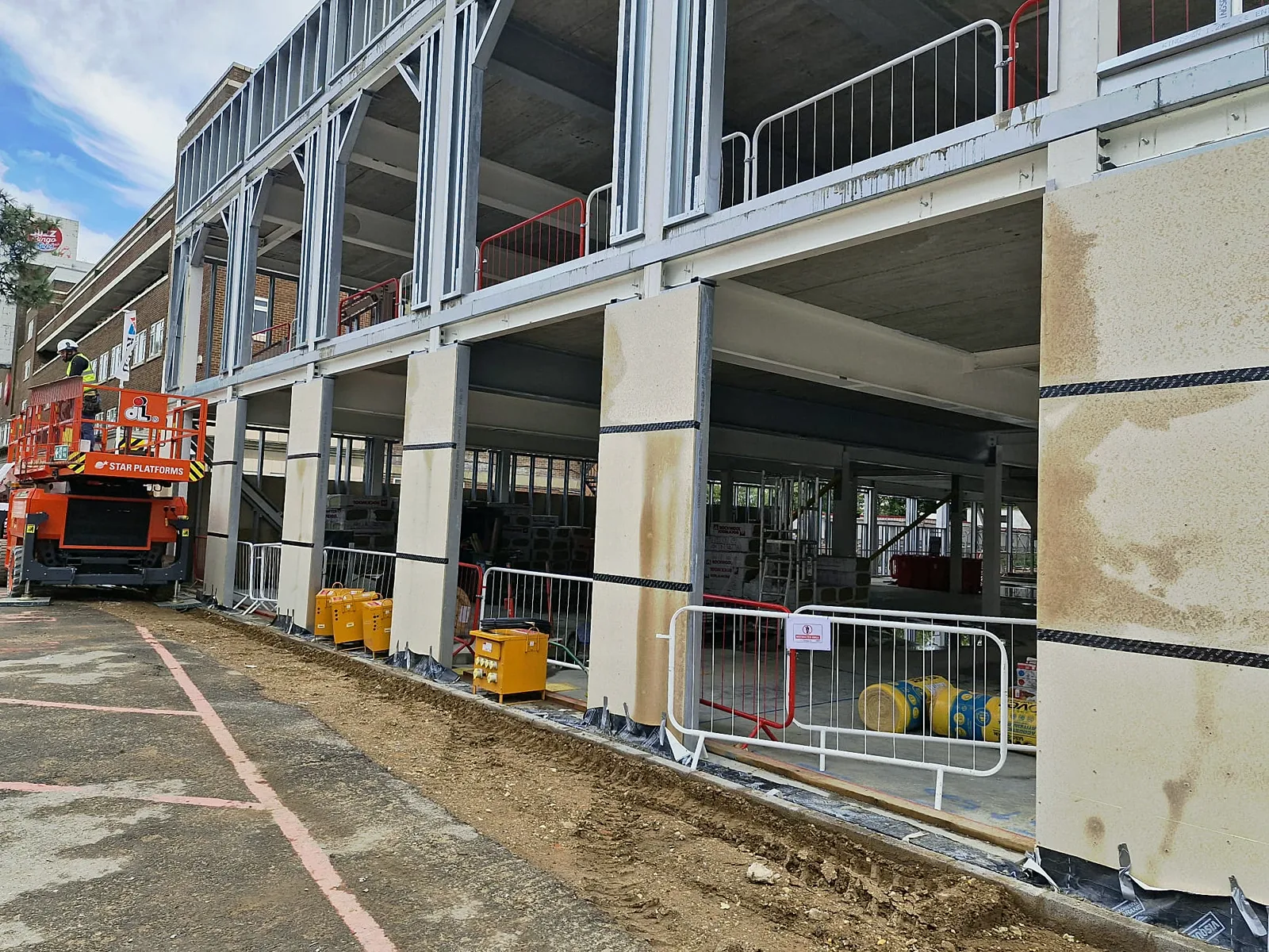 Steel stud framing on the upper floor with boarded columns below